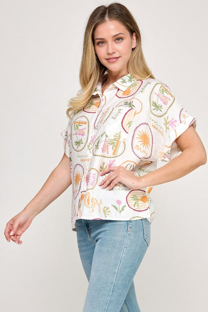 Woman wearing a patterned shirt and jeans on a plain background