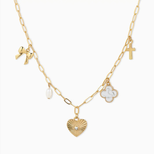 Gold necklace with various charms on a white background