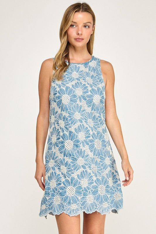 Woman wearing a blue floral dress on a white background