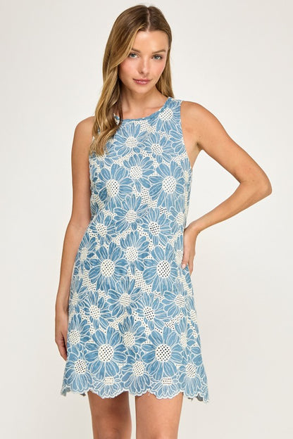 Woman wearing a blue floral dress on a white background