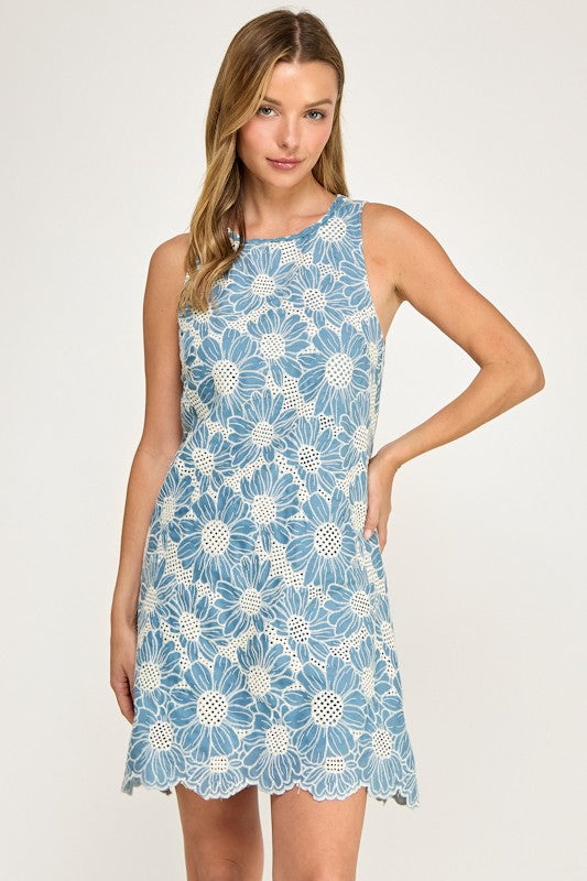 Woman wearing a blue floral dress on a white background
