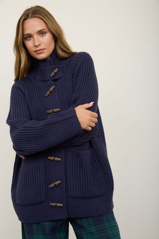 woman wearing navy cardigan with plaid pants