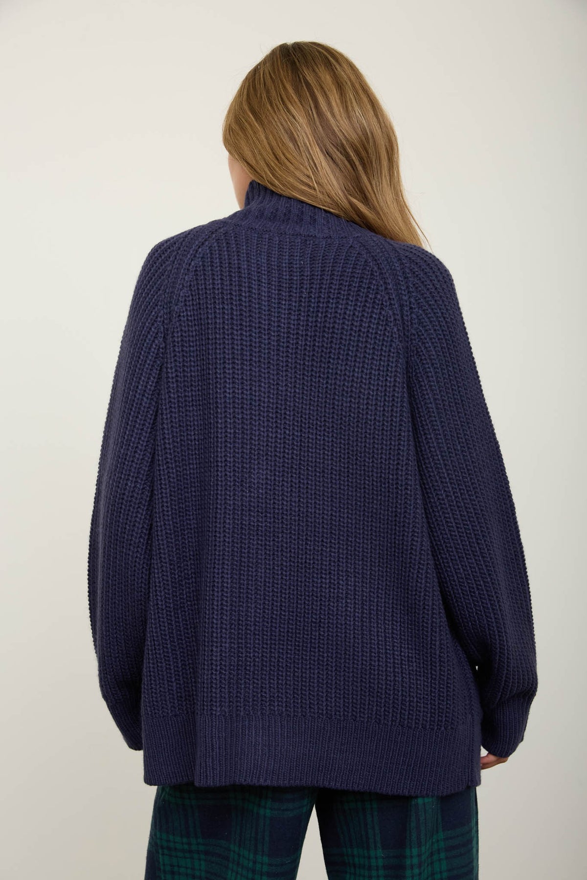 backside of woman wearing navy cardigan