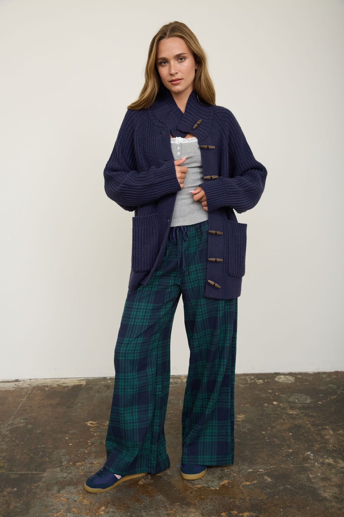 woman wearing navy cardigan with plaid pants