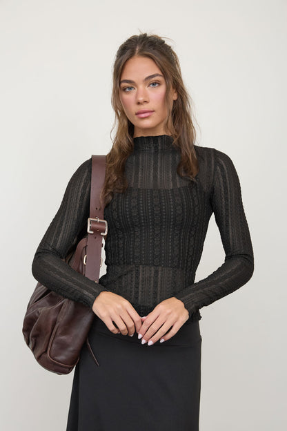 woman in long sleeve sheer top 