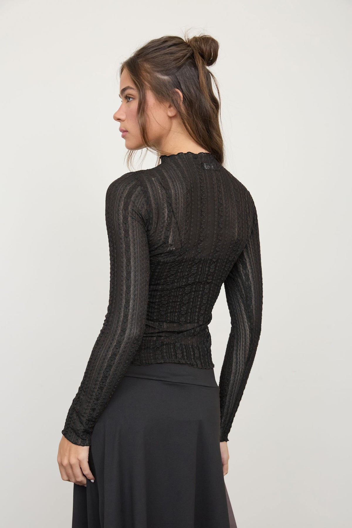 woman in long sleeve sheer top 