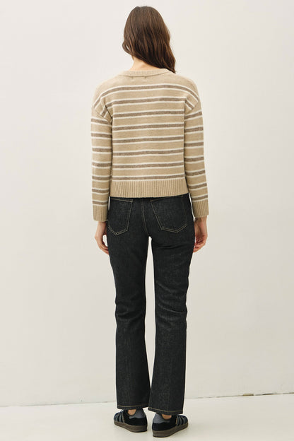 back view of woman in striped sweater and jeans 