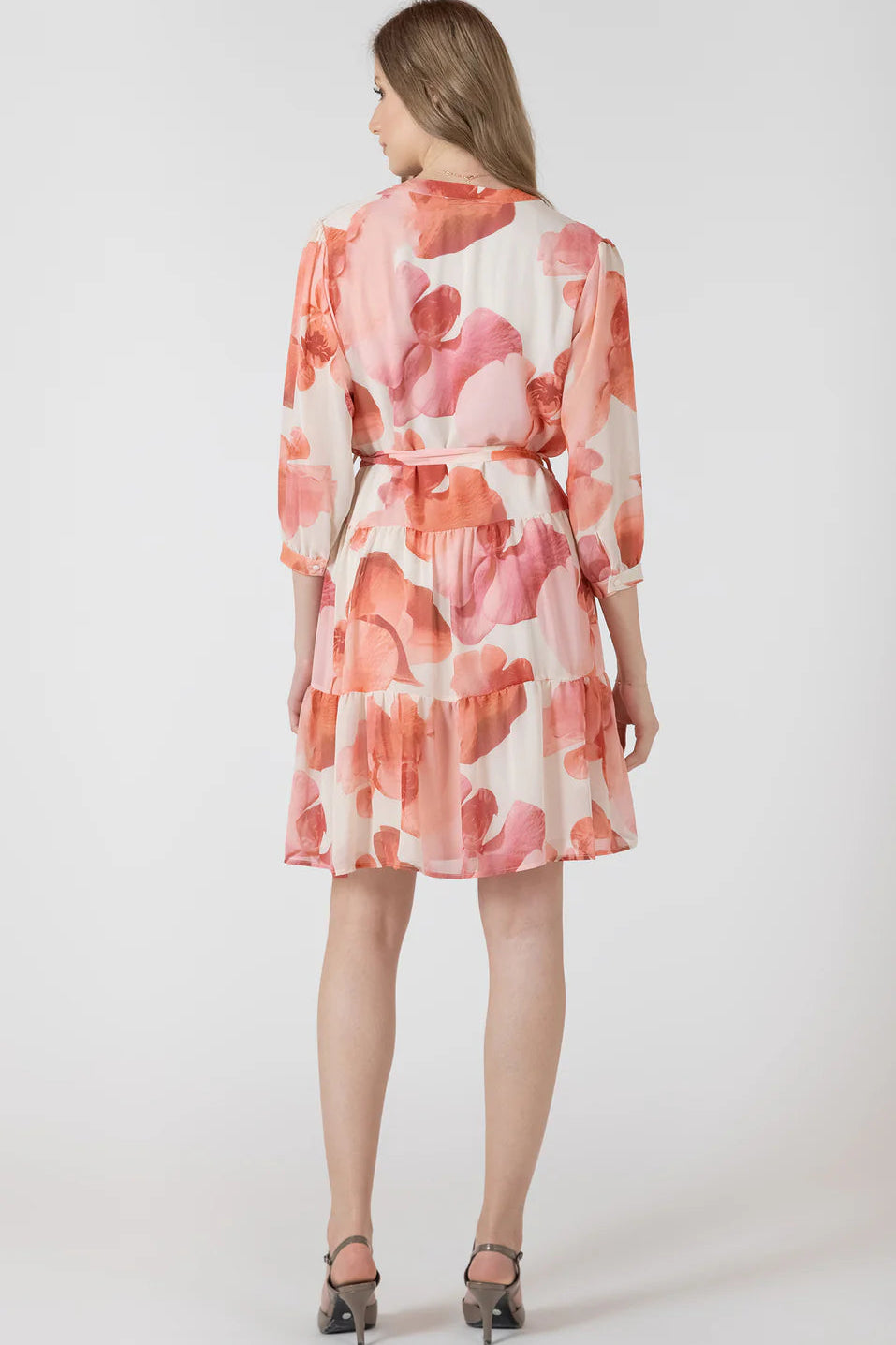 Woman wearing a floral dress on a white background