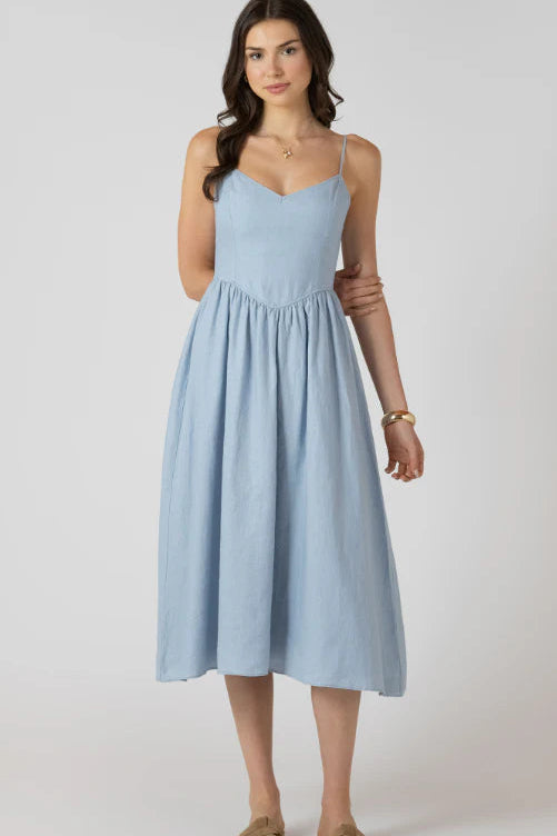 Woman wearing a light blue dress on a white background