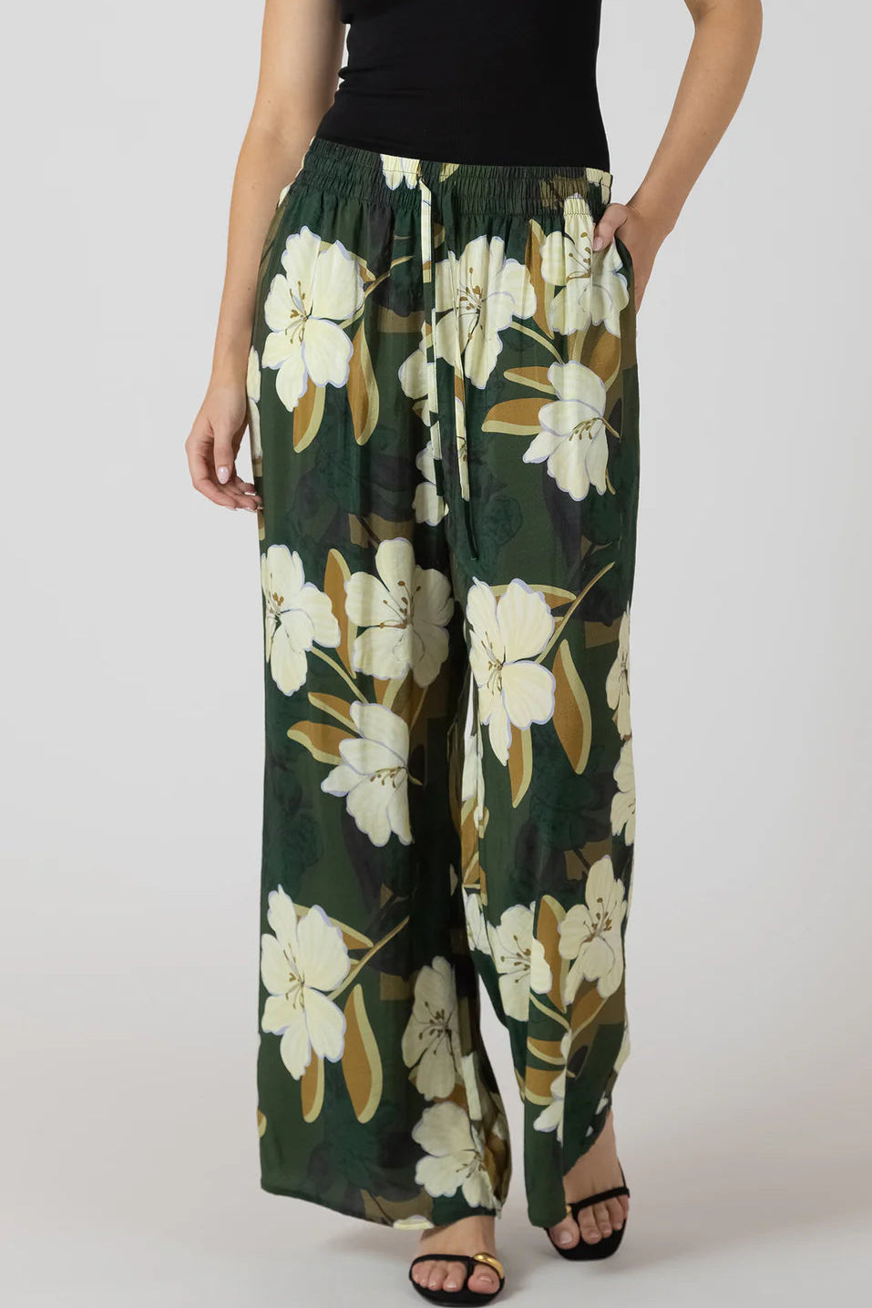 person wearing flowy pants with flower print 