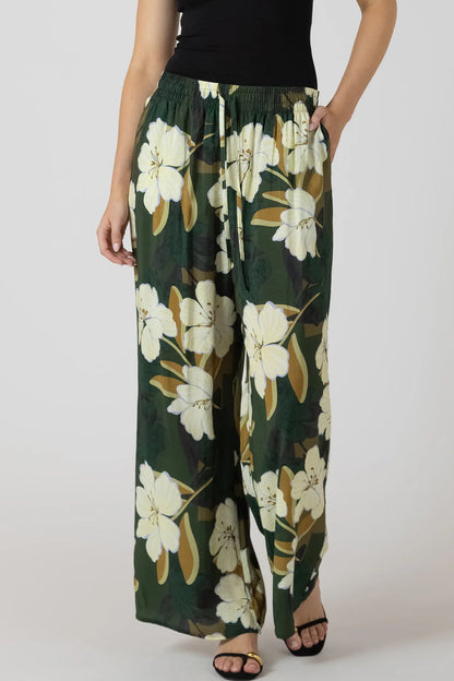 person wearing flowy pants with flower print 
