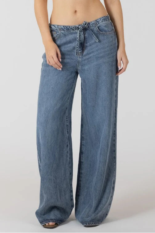 woman wearing denim wide leg pants with drawstring
