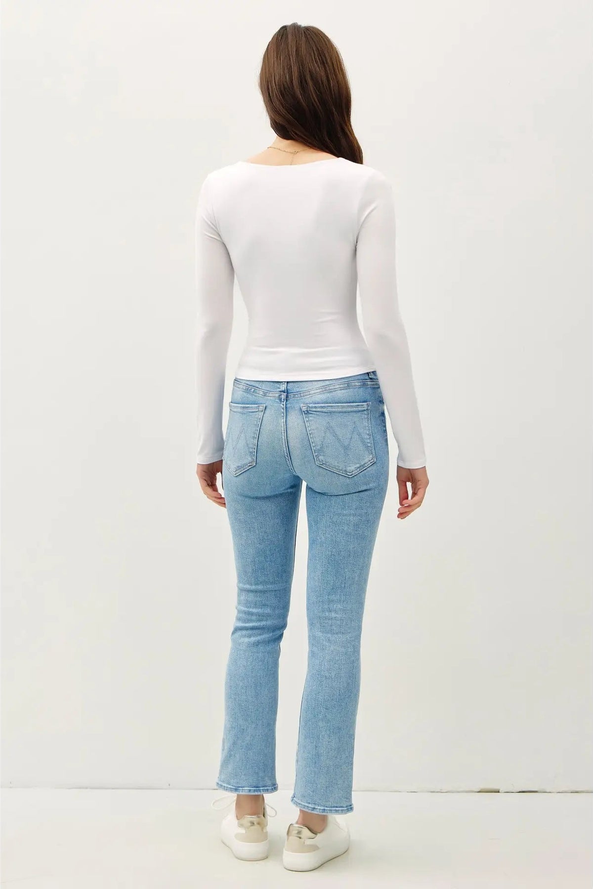 woman wearing square neck long sleeve top with jeans