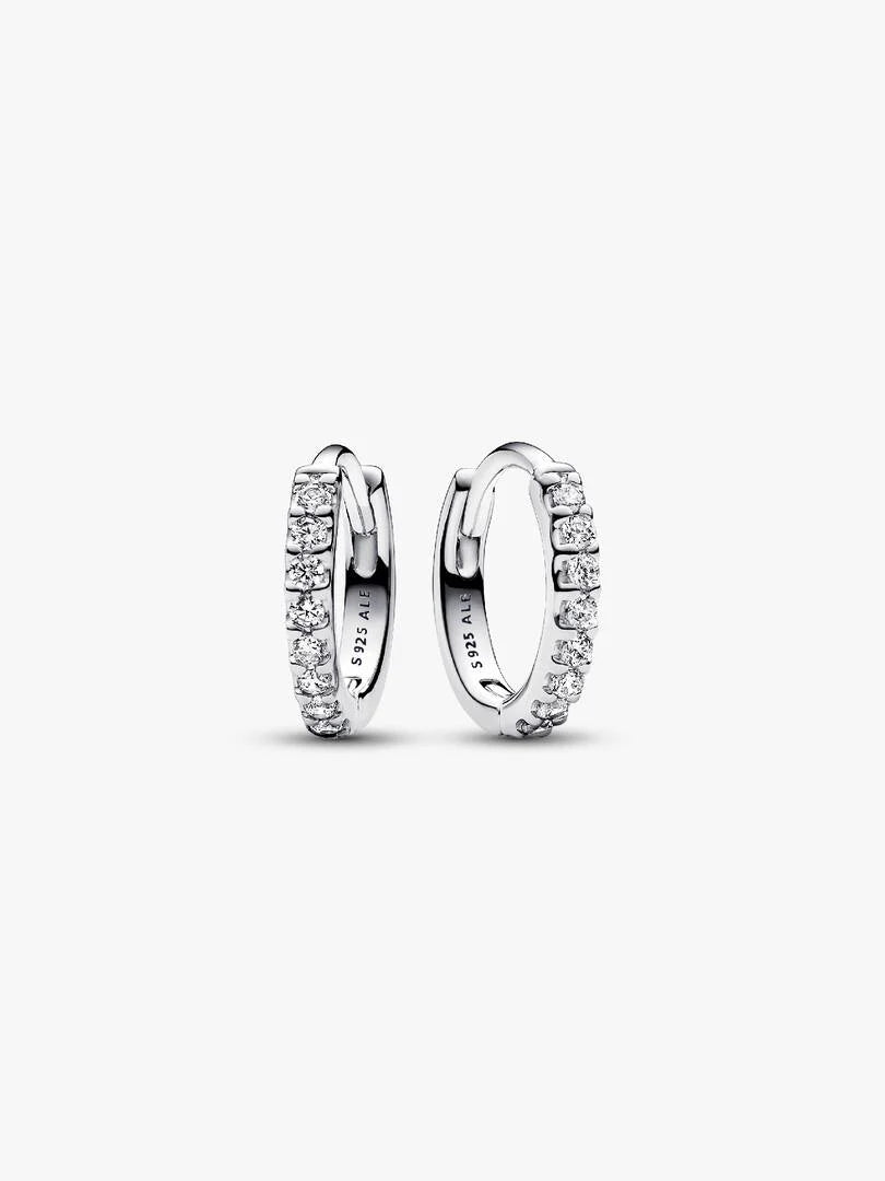 Pair of silver hoop earrings with clear gemstones on a white background