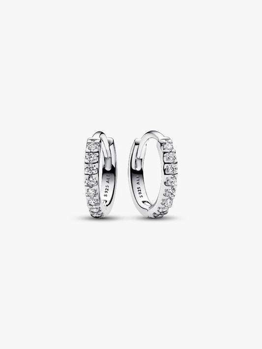 Pair of silver hoop earrings with clear gemstones on a white background