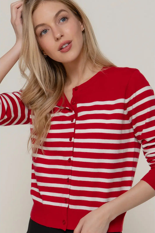 Woman wearing a red and white striped shirt against a plain background