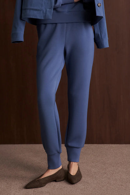 Blue pants worn by a person on a brown background