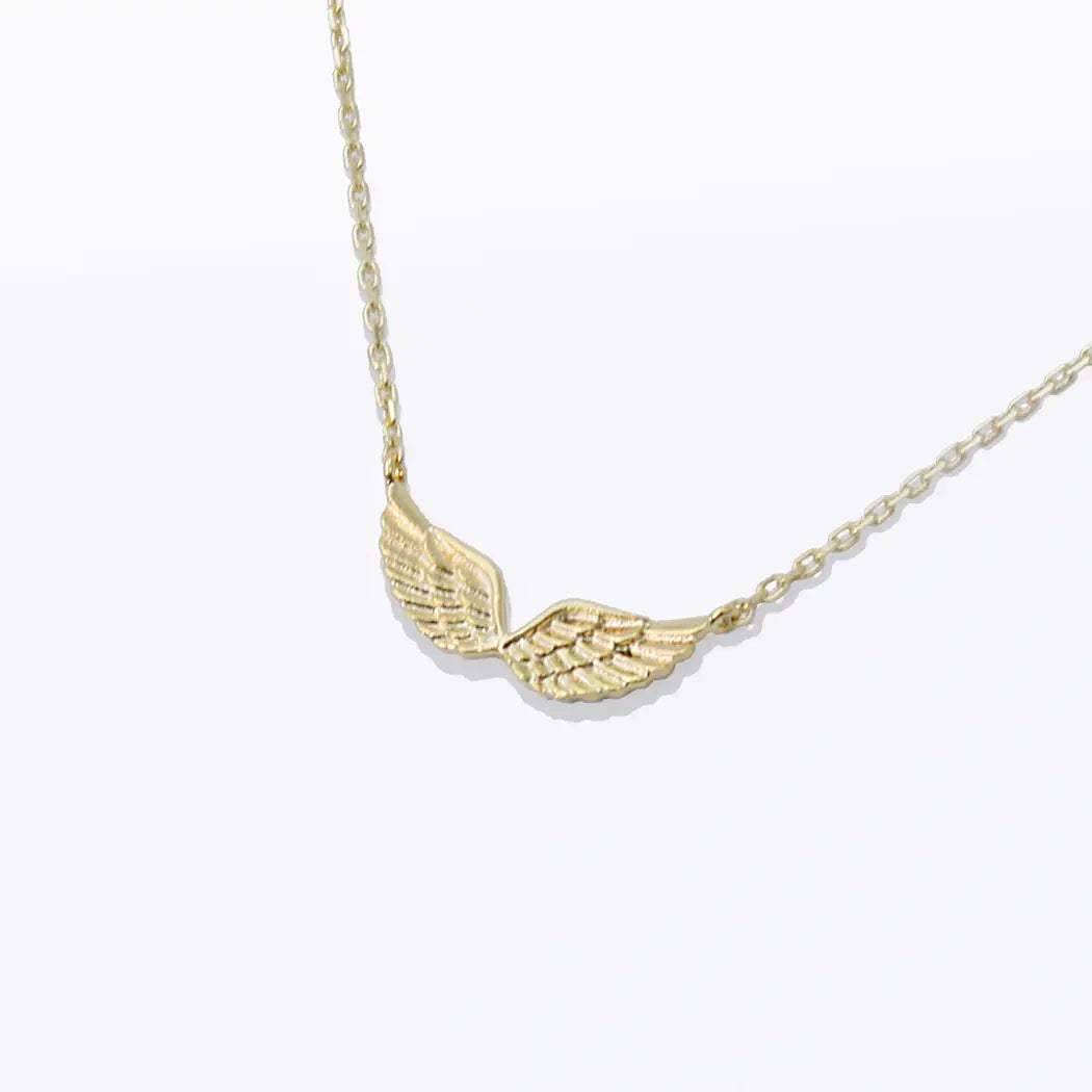 Gold wing-shaped pendant necklace on a white background