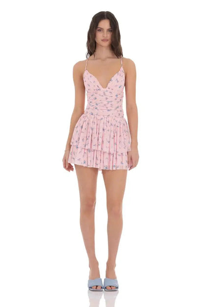Woman wearing a pink floral dress on a white background