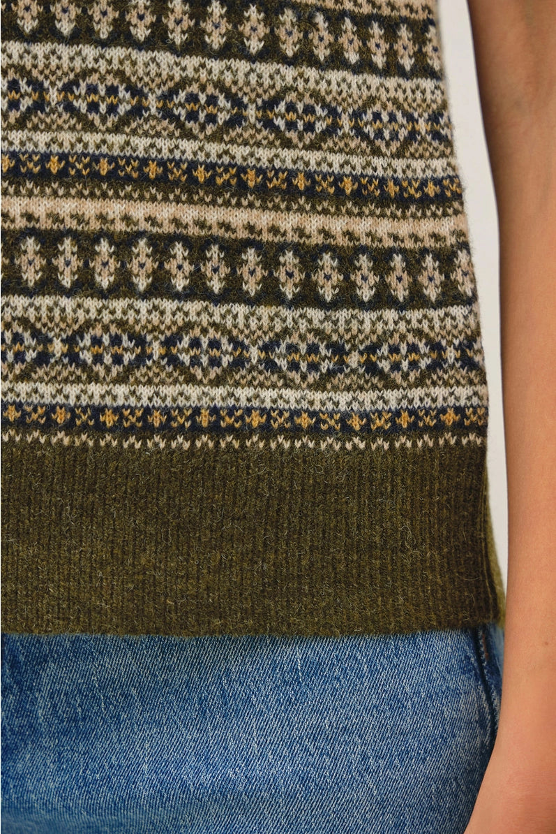 green sweater vest close up