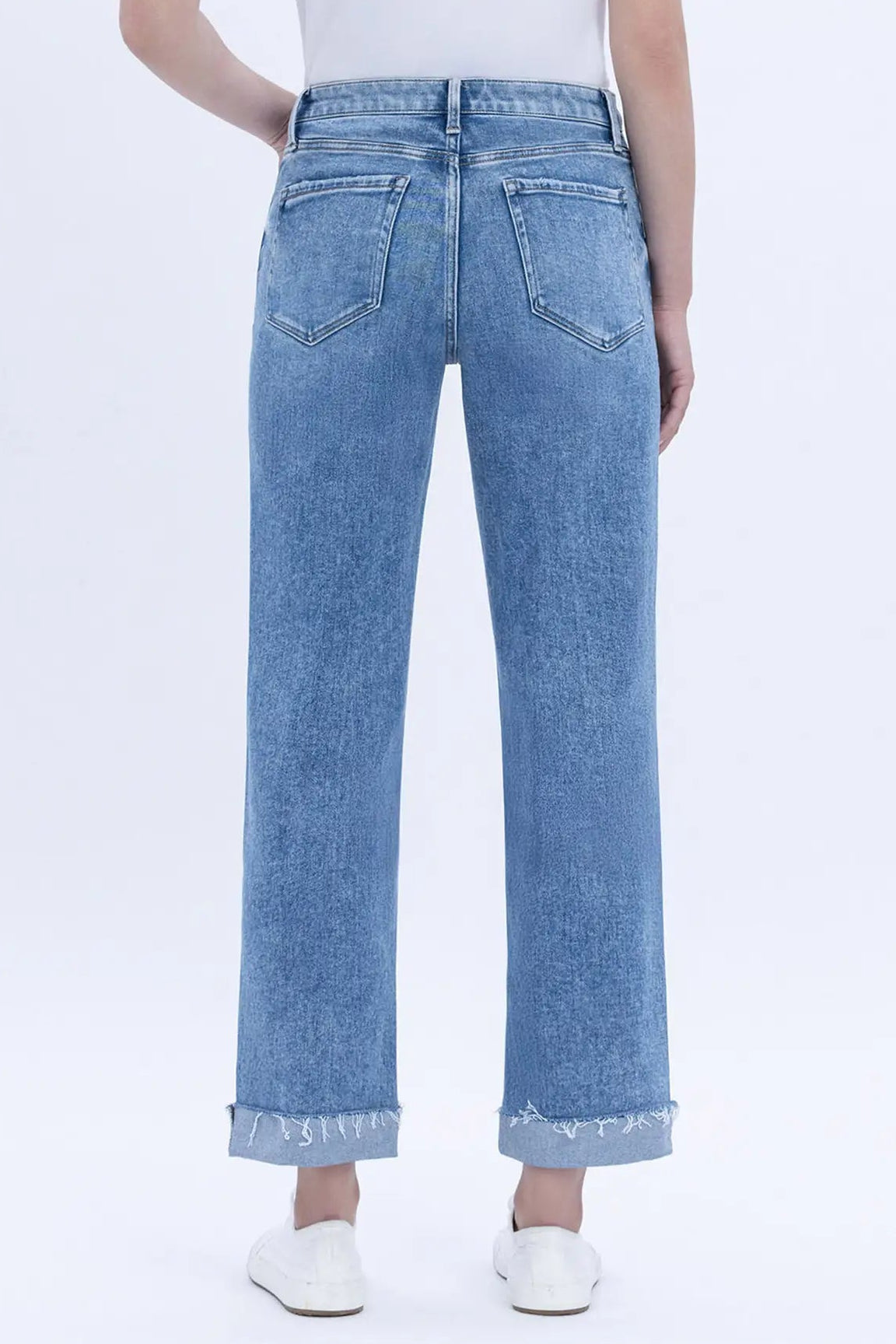 Light blue jeans worn by a person on a white background