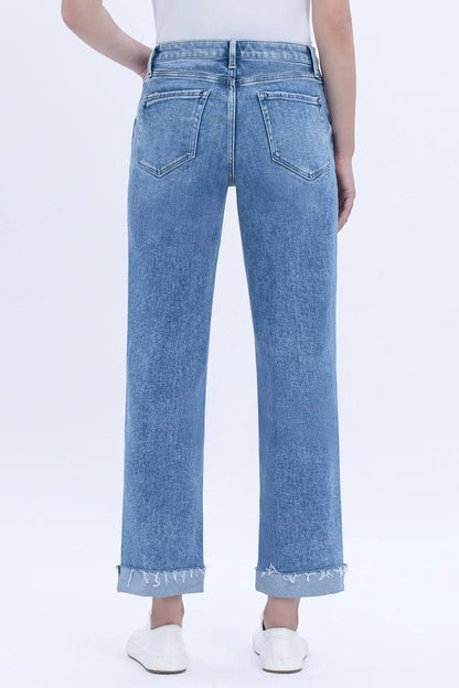Light blue jeans worn by a person on a white background