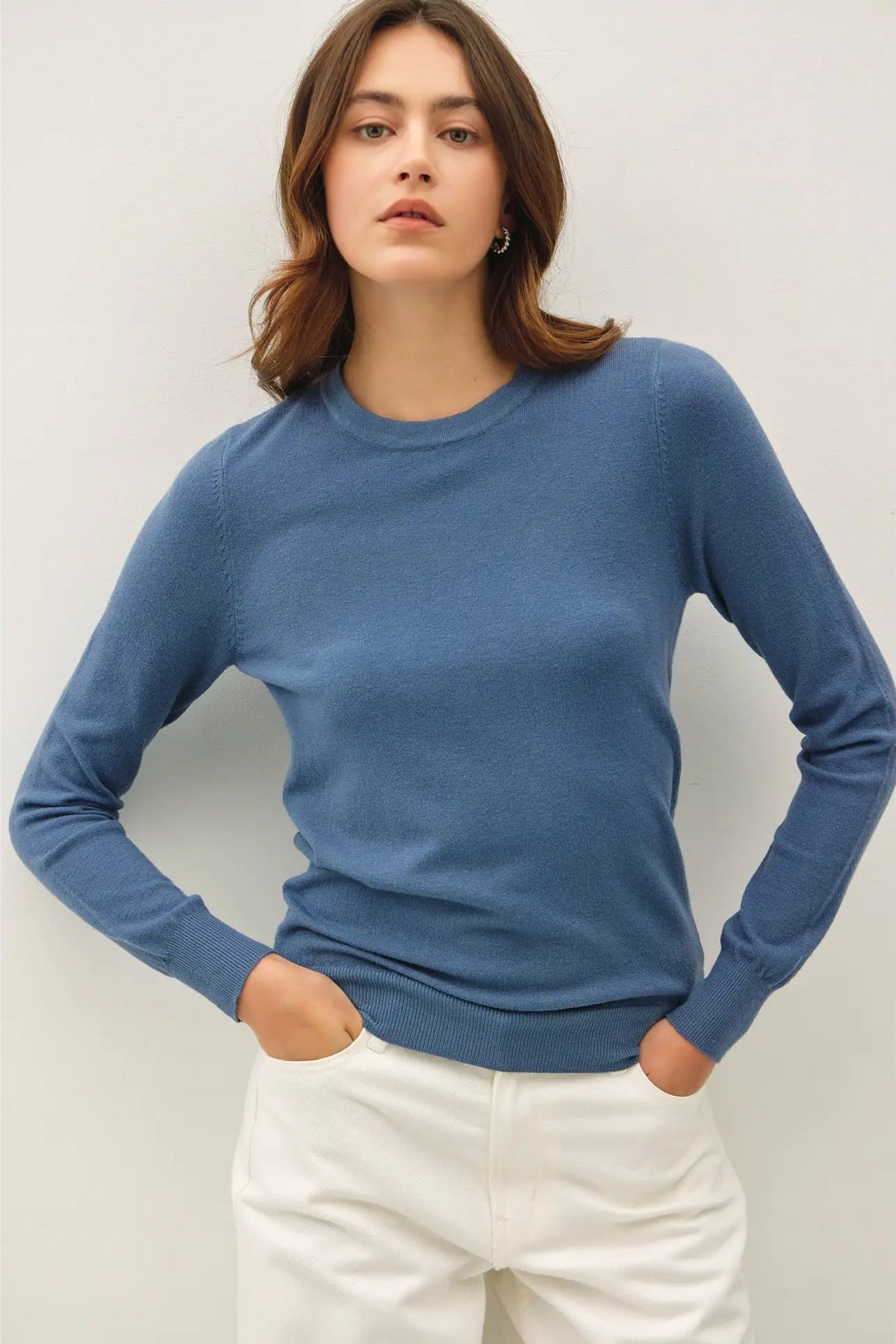 woman wearing sweater with white pants