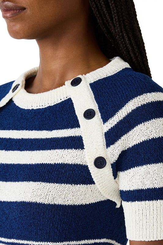 Close-up of a person wearing a blue and white striped sweater with button details.