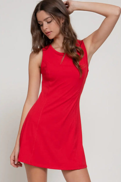 Woman wearing a red dress against a plain background