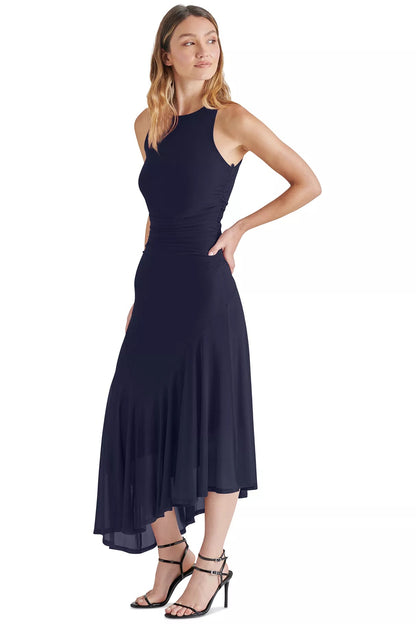 Woman wearing a navy blue dress on a white background