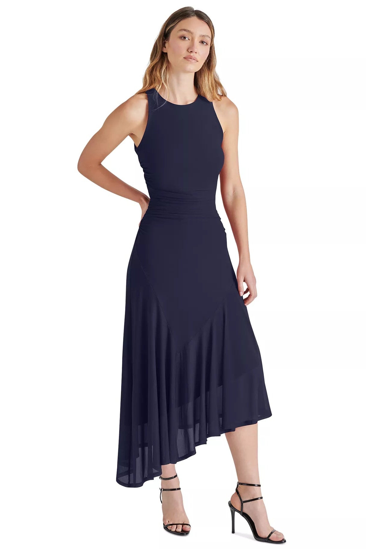 Woman wearing a navy blue sleeveless dress on a white background