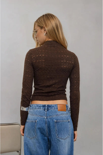 back view of woman in mock neck top and jeans