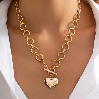 person wearing heart necklace