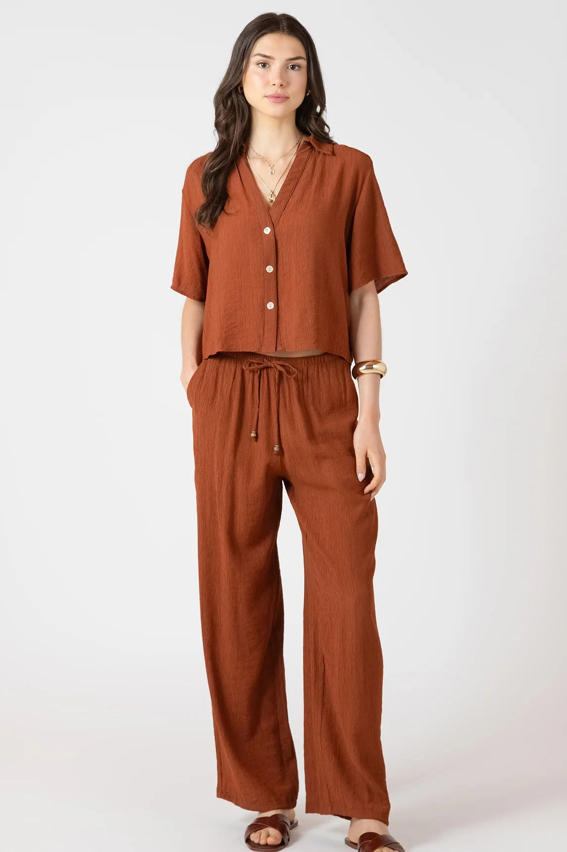 Woman wearing a brown outfit on a white background