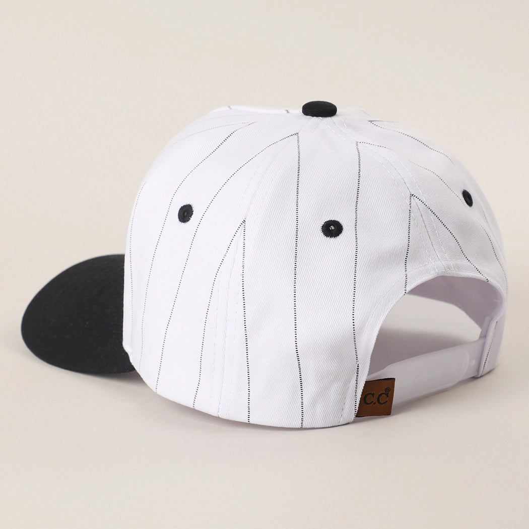 White cap with black accents on a beige background