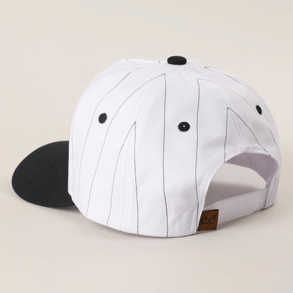 White cap with black accents on a beige background