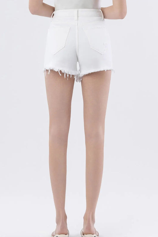 Person wearing beige sheer stockings with white shorts on a white background