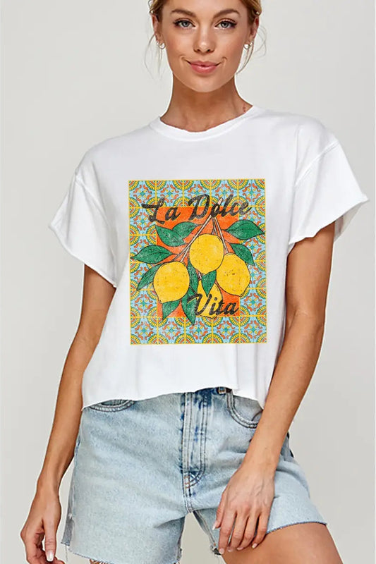 Woman wearing a white t-shirt with a colorful graphic design and text.