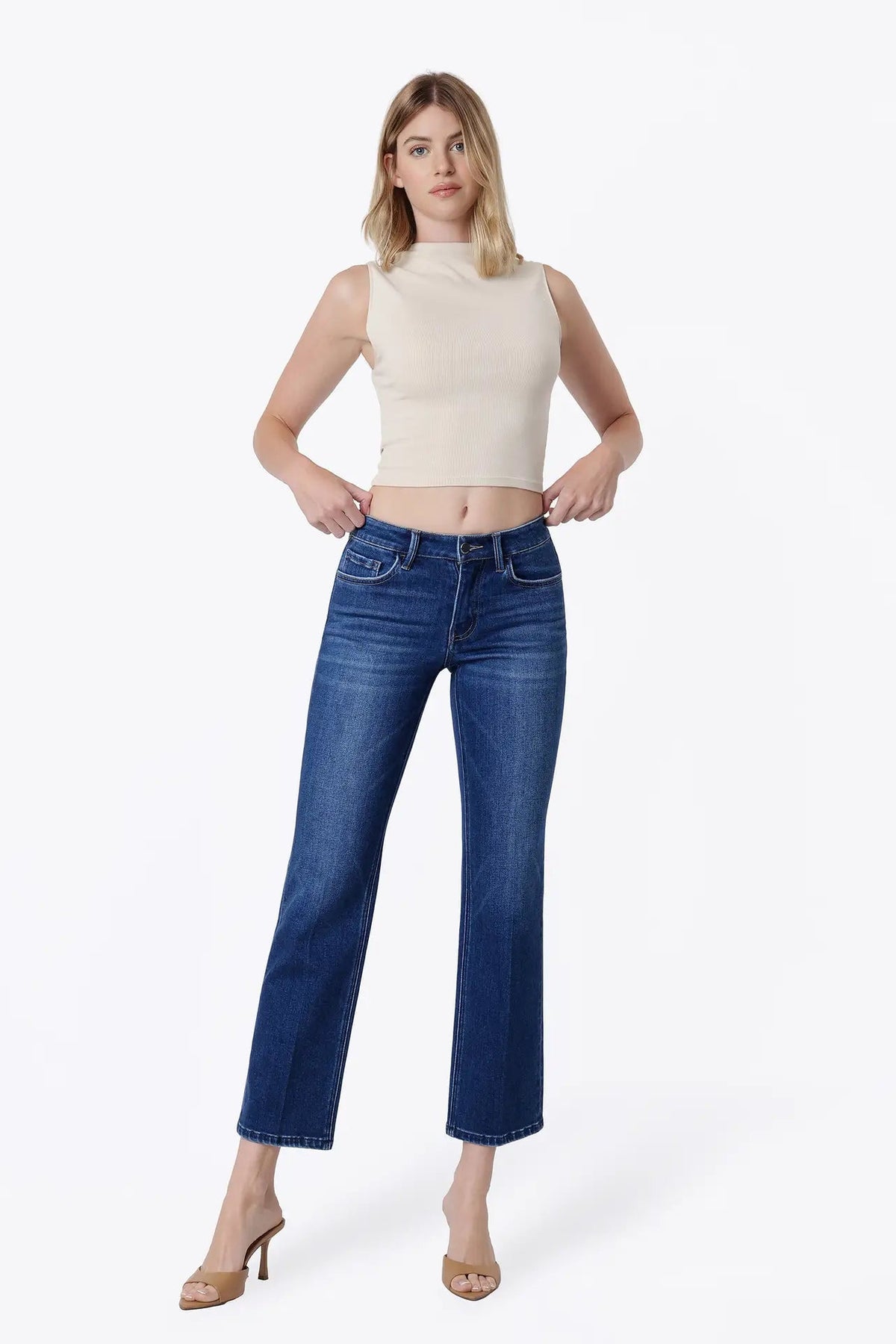 woman in white tank with dark wash jeans