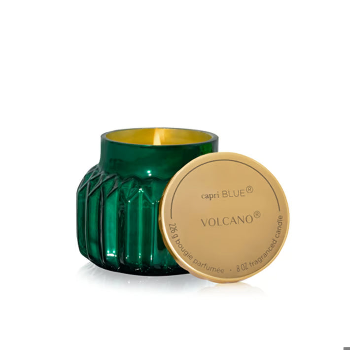 Green candle with gold lid labeled 'capri BLUE Volcano' on a white background