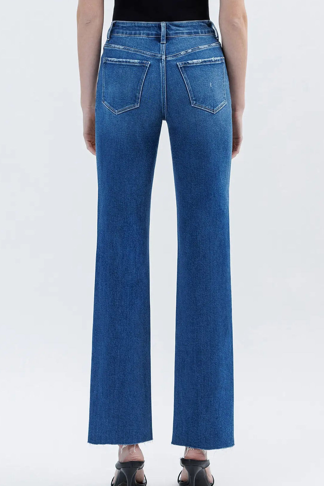 back view of person in medium wash jeans