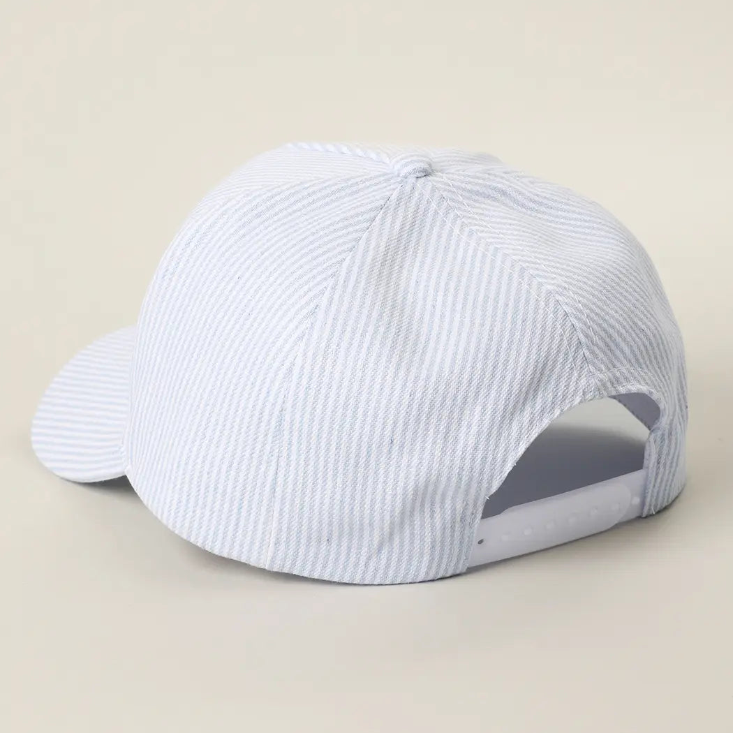 White cap with blue stripes on a beige background