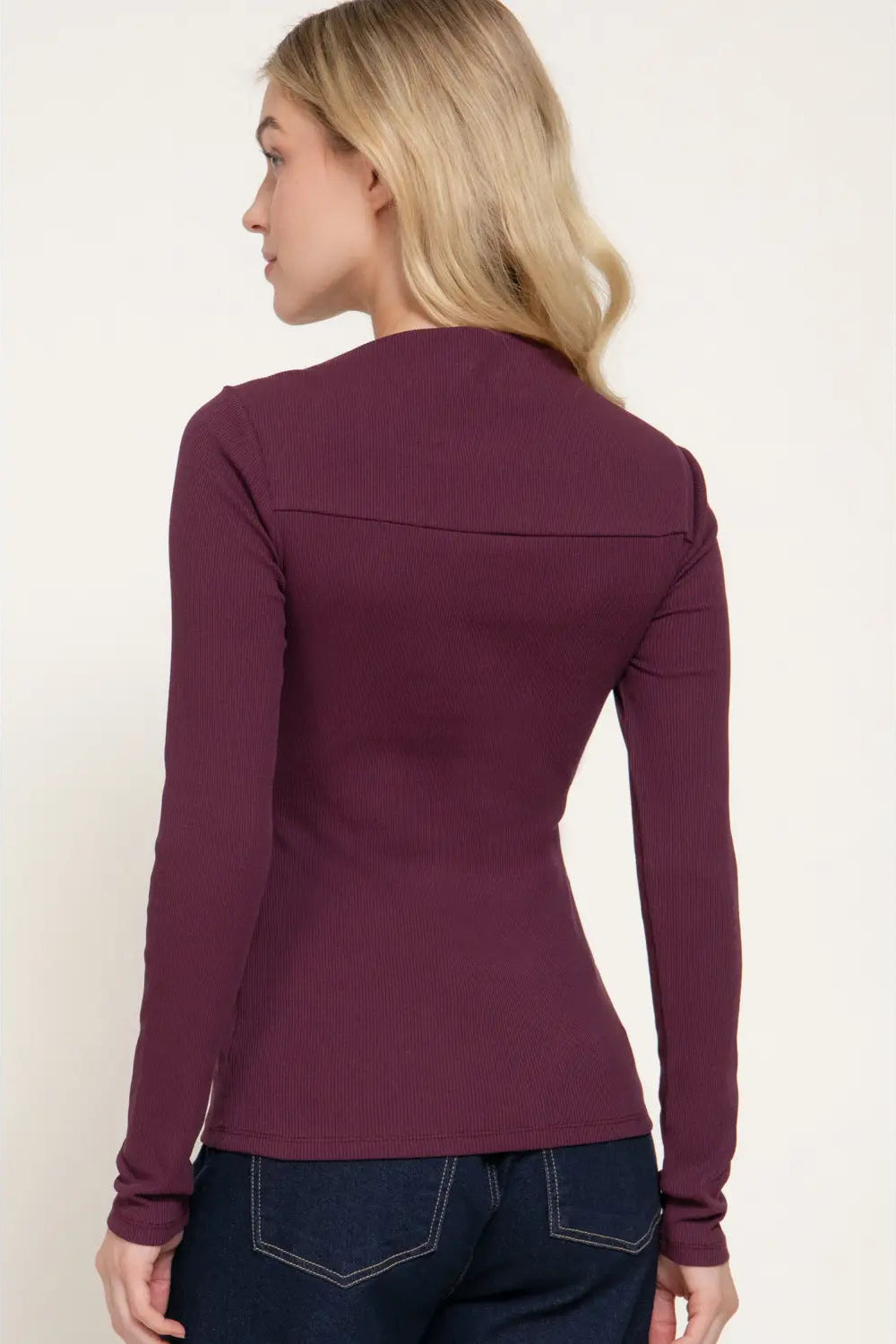 back view of woman in wine colored top 