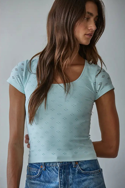 woman wearing green top and jeans
