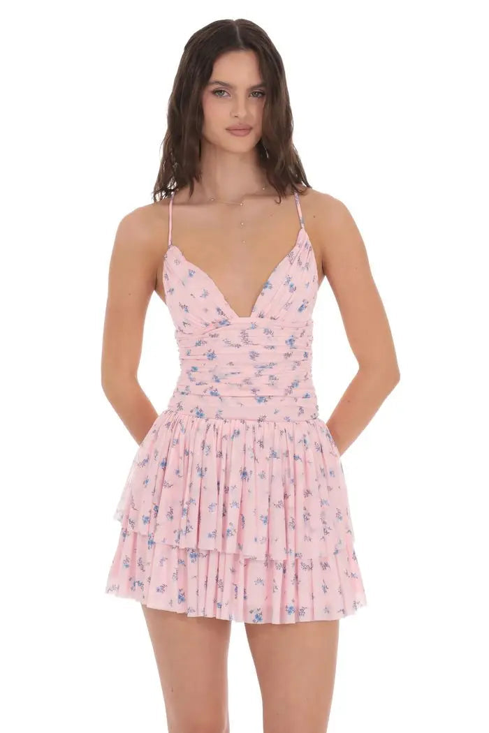 Woman wearing a pink floral dress on a white background