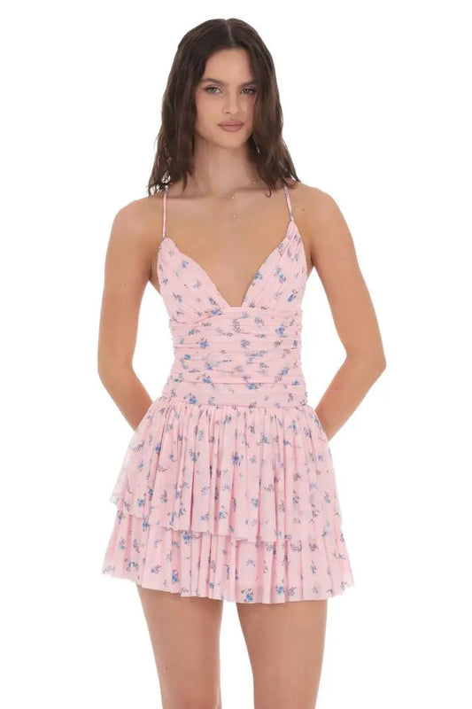 Woman wearing a pink floral dress on a white background