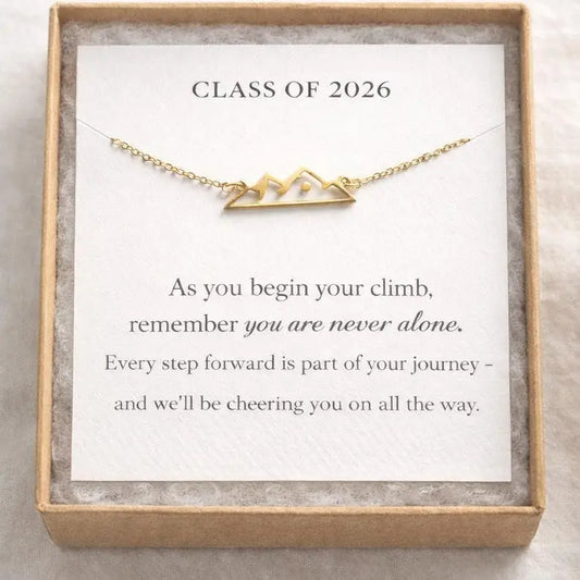 Gold necklace with 'Class of 2026' design on a card with motivational message.