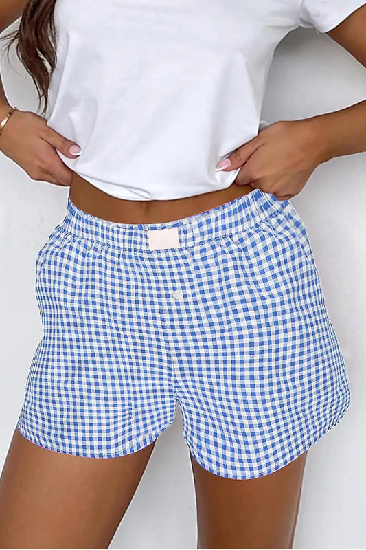 woman wearing gingham shorts and white top 