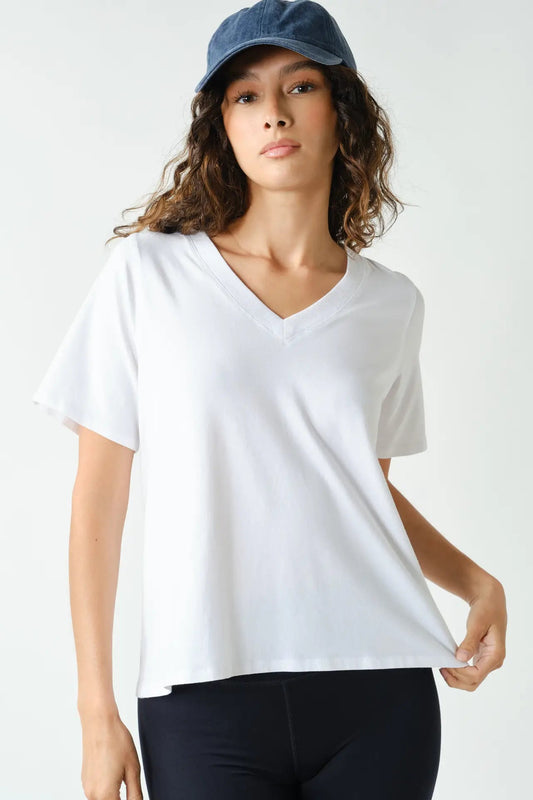 woman in white tee, hat and leggings