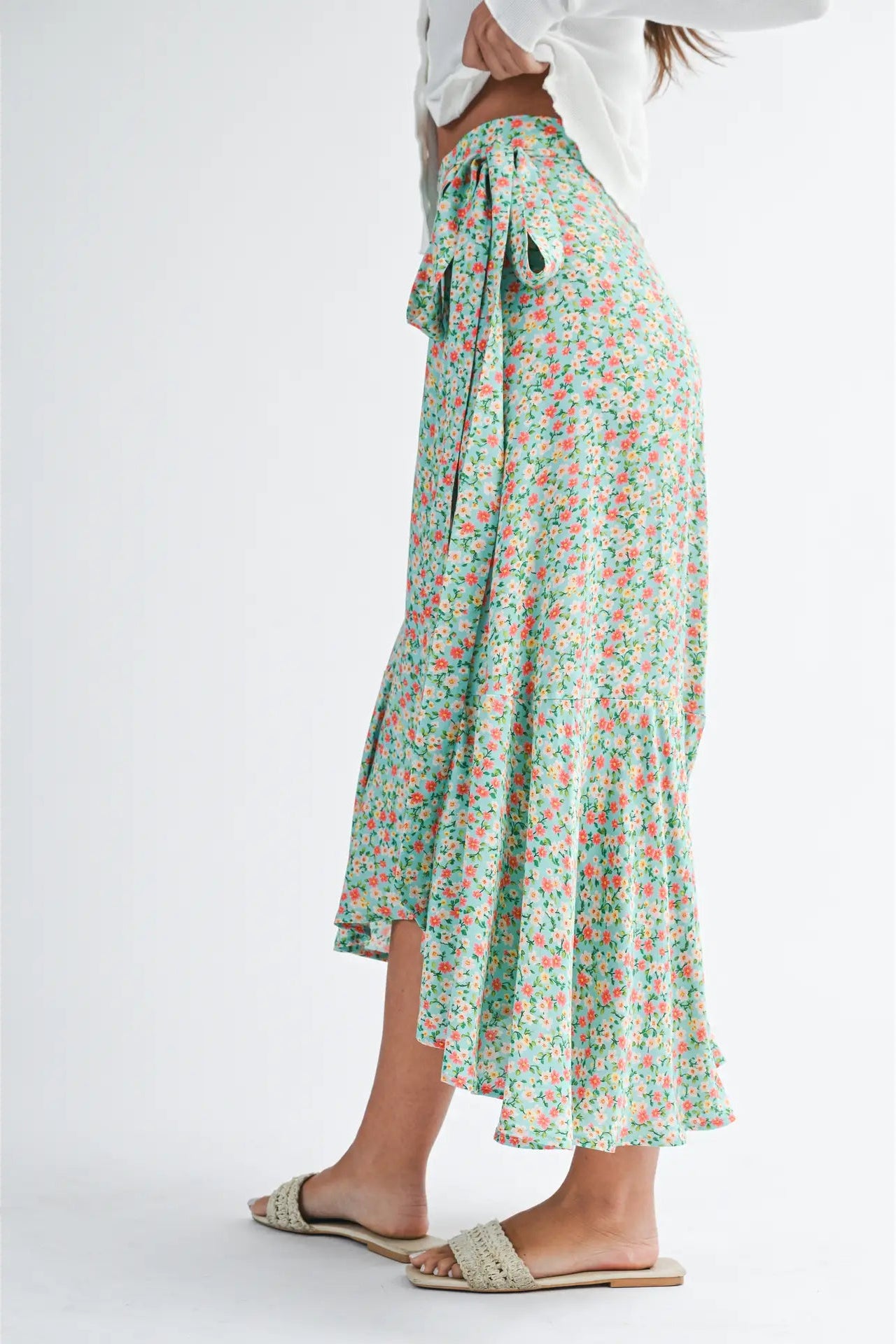 Floral skirt worn by a person on a white background
